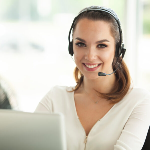 Female customer support operator with headset and smiling